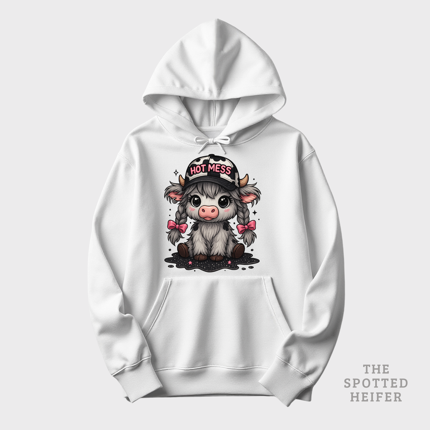 White hoodie featuring Hot Mess cow design with pink bows, braids, and cow-print hat, The Spotted Heifer.