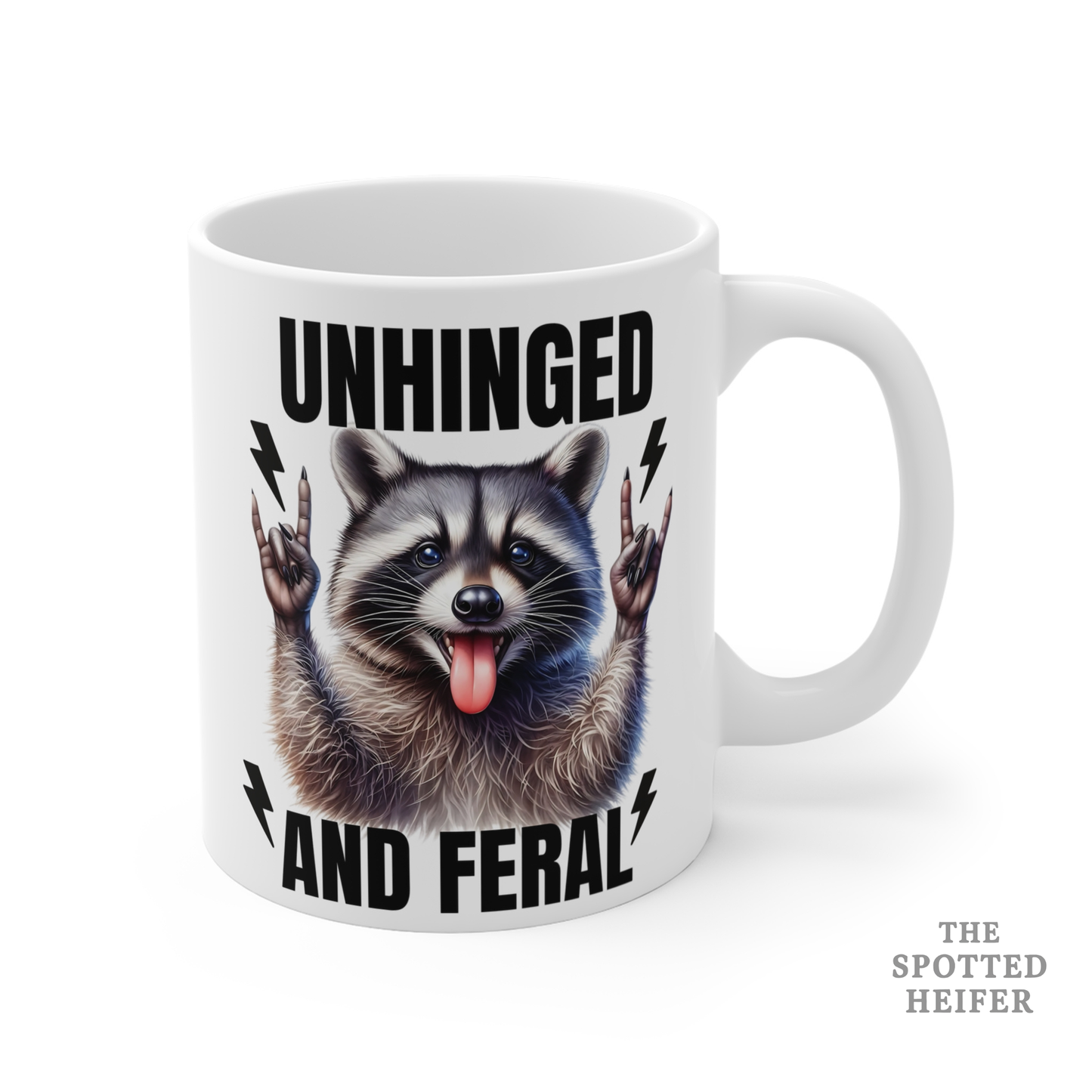 Right side of white Unhinged and Feral raccoon mug with handle visible, humorous raccoon illustration and bold black text.
