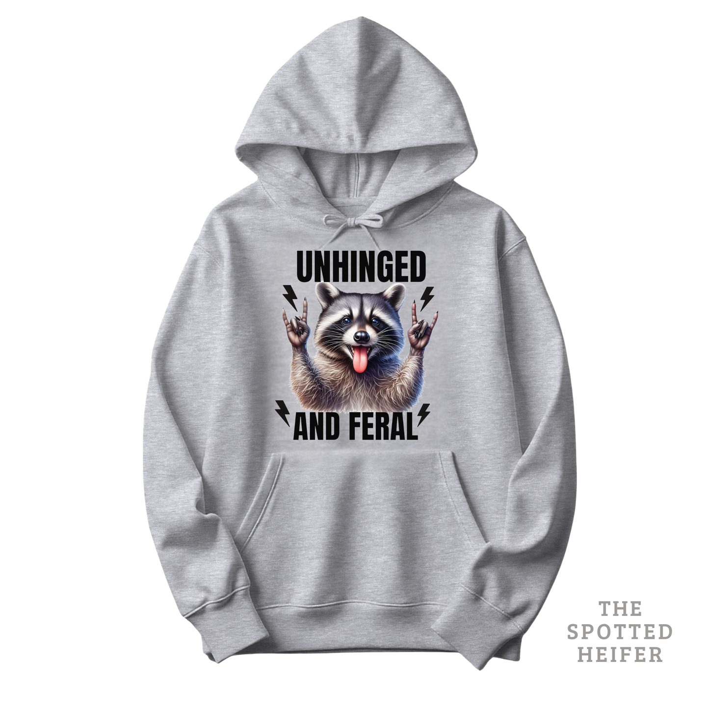 Sport gray Gildan 18500 hoodie featuring “Unhinged and Feral” text with a playful raccoon graphic on the front – cozy funny hoodie by The Spotted Heifer.